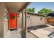 Home entrance featuring a vibrant red door, stylish lighting, and a well-maintained walkway at 1831 S Ivanhoe St, Denver, CO 80224