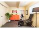 Home exercise room featuring an exercise bike, bright orange storage, and ample natural light at 1831 S Ivanhoe St, Denver, CO 80224