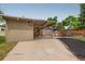 Home exterior showing a carport, red door, and an outdoor seating area, creating curb appeal at 1831 S Ivanhoe St, Denver, CO 80224
