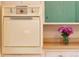 Retro-style kitchen featuring a vintage wall oven complemented by light countertops and green accent cabinets at 1831 S Ivanhoe St, Denver, CO 80224