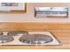 Close-up of a smooth electric cooktop built into the counter in this retro kitchen at 1831 S Ivanhoe St, Denver, CO 80224