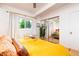 Bright and sunny main bedroom featuring hardwood floors, closet doors, and neutral walls at 1831 S Ivanhoe St, Denver, CO 80224