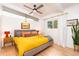 Sun-filled main bedroom with a ceiling fan, beamed ceiling, and stylish mid-century decor at 1831 S Ivanhoe St, Denver, CO 80224