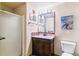 Modern bathroom featuring a glass shower door, mosaic tile accents, and a dark wood vanity at 444 17Th St # 1003, Denver, CO 80202