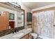 Stylish bathroom featuring granite countertop vanity, tiled accents and decorative shower curtain at 444 17Th St # 1003, Denver, CO 80202