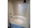Bright bathtub with a tiled wall and chrome fixtures at 444 17Th St # 1003, Denver, CO 80202