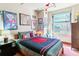 Comfortable bedroom with large window and eclectic decor at 444 17Th St # 1003, Denver, CO 80202