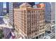 Aerial view of a brick building with many windows surrounded by other buildings in an urban landscape at 444 17Th St # 1003, Denver, CO 80202