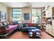 Bright living room boasts daybed and couch with built-in storage and city views at 444 17Th St # 1003, Denver, CO 80202