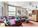 A naturally lit living room featuring a comfortable day bed and a modern bookcase at 444 17Th St # 1003, Denver, CO 80202