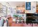 Cozy living room and piano featuring eclectic artwork and large windows at 444 17Th St # 1003, Denver, CO 80202