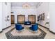 Elegant lobby with chandelier, plush seating, marble floors, and gold elevator doors at 444 17Th St # 1003, Denver, CO 80202