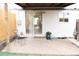 View of backyard with security door, chair, blue pot, and cement patio at 3073 W Center Ave # C, Denver, CO 80219