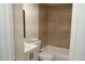 Comfortable bathroom with new vanity, toilet and tile bathtub surround at 3073 W Center Ave # C, Denver, CO 80219