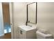 Clean bathroom featuring a modern vanity, rectangular mirror, and contemporary design at 3073 W Center Ave # C, Denver, CO 80219