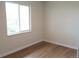 Bright bedroom with laminate flooring and a window at 3073 W Center Ave # C, Denver, CO 80219