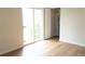 A bright bedroom with laminate floors, a sliding door, and a closet at 3073 W Center Ave # C, Denver, CO 80219