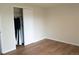 A bright bedroom featuring modern laminate floors and a closet at 3073 W Center Ave # C, Denver, CO 80219
