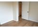 Bright bedroom with laminate flooring and open doorway at 3073 W Center Ave # C, Denver, CO 80219