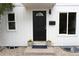 Charming front entrance with a modern black door, decorative window, and inviting landscaping at 3073 W Center Ave # C, Denver, CO 80219