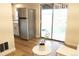 Bright kitchen featuring stainless steel refrigerator and sliding glass door to fenced-in yard at 3073 W Center Ave # C, Denver, CO 80219