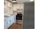 Modern kitchen with stainless steel appliances, white cabinetry, and a functional layout at 3073 W Center Ave # C, Denver, CO 80219