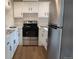 Updated kitchen featuring stainless steel appliances, white cabinets, and modern countertops at 3073 W Center Ave # C, Denver, CO 80219