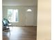 Inviting living room featuring hardwood floors, natural light, and a view of the front door at 3073 W Center Ave # C, Denver, CO 80219