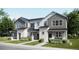 Charming townhome with modern farmhouse facade, attached garages, and inviting curb appeal at 6579 Parterre N Pkwy # 3, Thornton, CO 80602