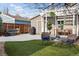 Beautiful backyard featuring a pergola, patio, artificial turf, and professional landscaping at 1194 S Washington St, Denver, CO 80210