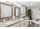 Bathroom with double vanity, granite countertop, and subway tile shower at 1194 S Washington St, Denver, CO 80210