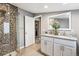 Bathroom featuring a granite countertop double vanity and tiled walk-in shower at 1194 S Washington St, Denver, CO 80210