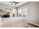 Bright bedroom features a ceiling fan, neutral walls, and large window at 1194 S Washington St, Denver, CO 80210