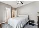 Neutral bedroom featuring a ceiling fan, white comforter, and dark colored nightstand at 1194 S Washington St, Denver, CO 80210