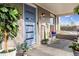 Inviting front porch featuring a blue door, decorative plants, and comfortable seating, creating a welcoming entrance at 1194 S Washington St, Denver, CO 80210