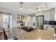 Spacious kitchen featuring granite countertops, stainless steel appliances, and a view of adjacent dining and bar area at 1194 S Washington St, Denver, CO 80210