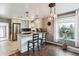 Modern kitchen featuring stainless steel appliances, granite countertops, breakfast bar, and stylish lighting fixtures at 1194 S Washington St, Denver, CO 80210