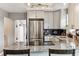Sleek kitchen with stainless steel appliances, granite counters, subway tile backsplash, and modern cabinetry at 1194 S Washington St, Denver, CO 80210