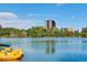 Scenic lake view with trees, blue sky, and watercraft for a peaceful neighborhood feel at 1194 S Washington St, Denver, CO 80210