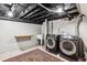 Spacious laundry room with modern washer, dryer, utility sink, storage shelf, and rug at 1194 S Washington St, Denver, CO 80210