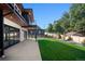 Well maintained lawn in the backyard of a modern home with a patio, wood fence, and mature trees at 5358 Lions Paw St, Castle Rock, CO 80104