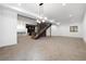 Spacious finished basement with carpet flooring, staircase, and modern light fixture at 5358 Lions Paw St, Castle Rock, CO 80104