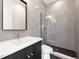 Bathroom featuring tiled walls, modern vanity, and glass-enclosed shower at 5358 Lions Paw St, Castle Rock, CO 80104