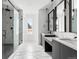 Modern bathroom with marble tile, glass shower, and dual vanities at 5358 Lions Paw St, Castle Rock, CO 80104