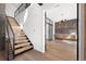 Elegant entryway with modern staircase, hardwood floors, and stylish wall accents at 5358 Lions Paw St, Castle Rock, CO 80104