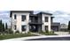 Modern two-story home featuring a balcony, dark framed windows, light colored siding, and lush landscaping at 5358 Lions Paw St, Castle Rock, CO 80104