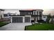 Striking modern home with multi-car garage, mixed materials, and manicured lawn enhance curb appeal at 5358 Lions Paw St, Castle Rock, CO 80104