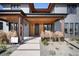 Close-up of the entryway showcasing wooden accents, modern landscaping, and a concrete walkway at 5358 Lions Paw St, Castle Rock, CO 80104