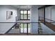 Hallway of a home featuring sleek banisters, hardwood floors, modern lighting, and scenic window views at 5358 Lions Paw St, Castle Rock, CO 80104