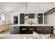 Modern kitchen featuring a large island with seating, sleek cabinets, and stylish pendant lighting at 5358 Lions Paw St, Castle Rock, CO 80104